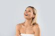 © Prostock-studio - Happy middle aged pretty lady laughing on grey studio background