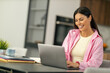 © ivanko80 - Smiling female freelancer working at home