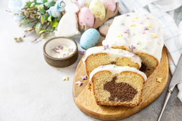 Wall Mural - Happy Easter holiday food baking, cupcake with Easter Bunny and colorful eggs on stone background. Copy space.