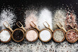 Colorful mix of salt varieties: sea and black, table and pink, himalayan and celtic. Food ingredients on dark background