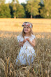 © milenie - Cute little girl in white dress walking in the wheat field, summer time, happiness