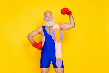 Canvas Print - Portrait of handsome powerful grandfather showing biceps wear winner belt isolated on yellow color background