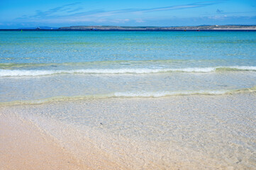 Wall Mural - St Ives, sandy beach in West Cornwall, South West, United Kingdom. View of the beach, beautiful blue sea. Popular holiday town, selective focus