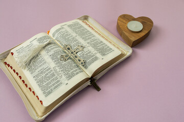 Wall Mural - open bible in Russian cross and candle holder in the shape of a heart