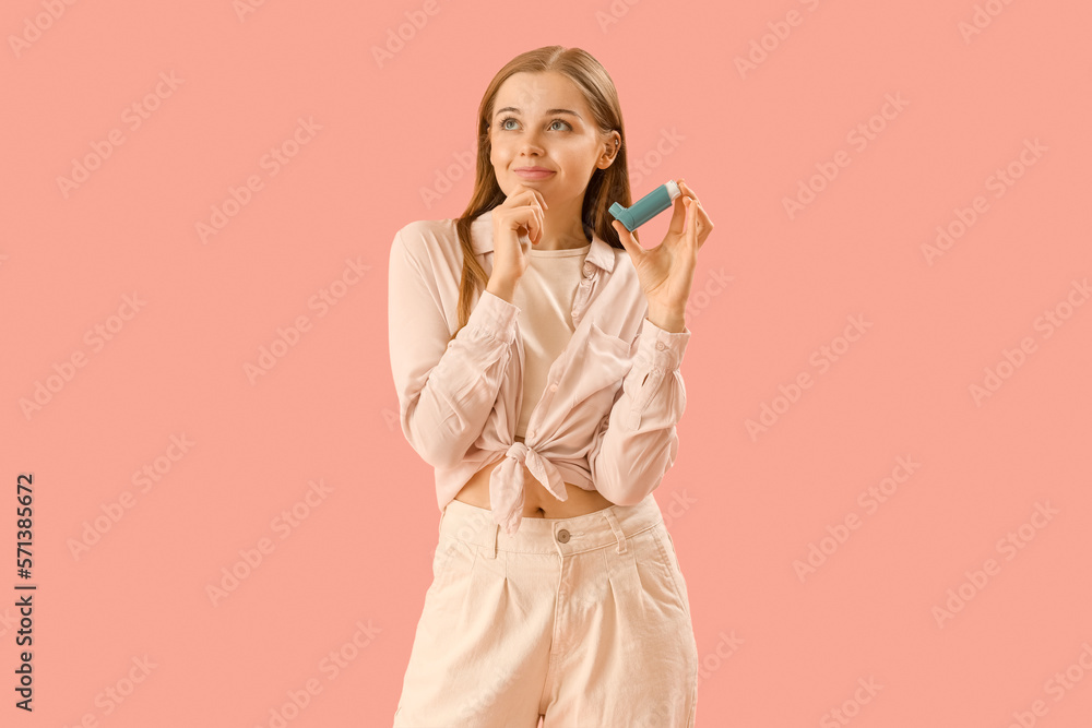 Thoughtful young woman with inhaler on pink background