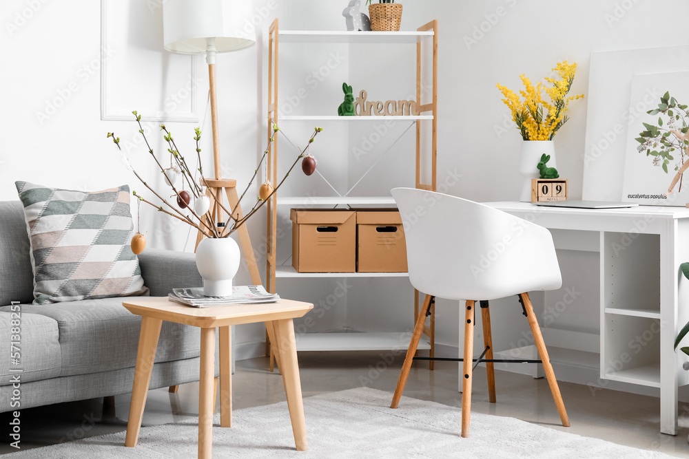 Stylish interior of light living room with Easter decor