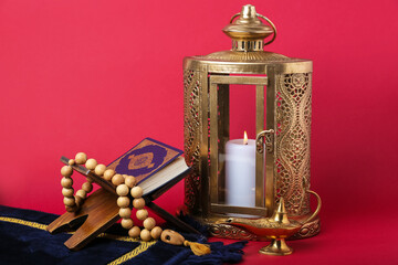 Wall Mural - Muslim lantern with Koran and prayer beads for Ramadan on red background