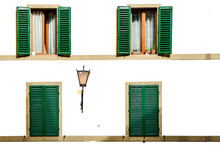 Four Green Shutters Open And Closed On A White Facade