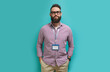 © San4ezz007 - Young caucasian man with a beard in glasses for vision with a blank badge isolated on a blue color background