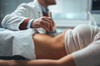 © Dragana Gordic - Sonographer using ultrasound machine at work. Modern clinical diagnostics and treatment. Close-up ultrasound scanner in hand of doctor. Doctor ultrasound examine female patient abdomen at hospital