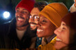 © CarlosBarquero - Close up portrait of multi-racial boys and girls smiling and taking selfie in winter. Young adults gathered outdoor at night. Group of cheerful colleagues happily in the countryside.