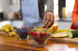 © Wavebreak Media - Diverse teenage female friends preparing healthy drink with fruit