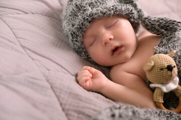 Wall Mural - Cute newborn baby sleeping with teething toy in bed, closeup