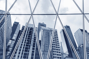 Wall Mural - Reflection of city skyline on the exterior of modern office building