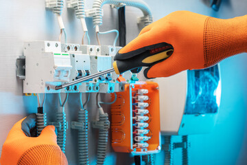 Wall Mural - Electrician is repairing the switchboard voltage. Close-up of Electrician at work.