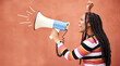Megaphone, anger or black woman in protest with speech announcement for politics, equality or human rights. Young feminist leader, fighting or angry gen z girl shouting for justice on wall background