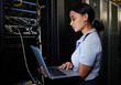 © Nina L/peopleimages.com - Engineer, laptop database and woman in server room for software update or maintenance at night. Cybersecurity coder, cloud computing and female programmer with computer for networking in data center.