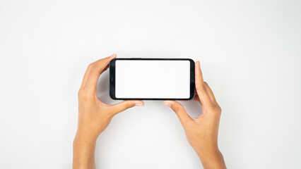 Two hands holding white blank smartphone horizontally