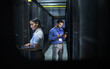 © Nina L/peopleimages.com - Man, woman or technology in server room, IT engineering or software programming for cybersecurity, analytics or database safety. Data center, programmer or coding developer on cloud, laptop or tablet