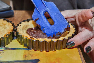 Canvas Print - Manufacturing process Round cream pie with chocolate and strawberries. French recipe