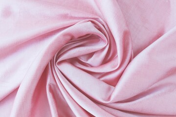 Texture of pink natural silk, folds, background for romantic congratulations, emotion of love