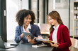 © Nuttapong punna - Two businesswoman discuss investment project working and planning strategy with tablet laptop computer in modern office..