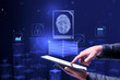 © Who is Danny - Online biometric authorization and personal data security concept with man finger on digital tablet touch screen and virtual projection of fingerprint with social network icons on blue background