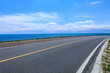 Asphalt road and lake with sky clouds natural scenery in Xinjiang, China.