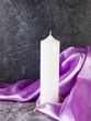 Decorative candles on lilac satin with flowers and beads