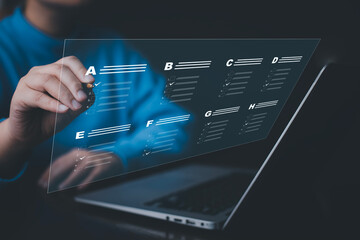 Businessman using a laptop and Taking an assessment, questionnaire, evaluation, online survey online exam Choosing the right answer in exam by filling out the online survey form,Answer  test questions