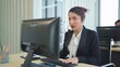 © M Stocker - Young Asian woman customer support phone operator with headset working in call center