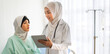 © Art_Photo - Muslim asian woman doctor service help support discussing and consulting talk to muslim woman patient at meeting health medical care express trust concept in hospital.healthcare and medicine