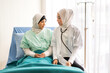 © Art_Photo - Muslim asian woman doctor service help support discussing and consulting talk to muslim woman patient at meeting health medical care express trust concept in hospital.healthcare and medicine