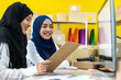 © Art_Photo - Muslim two asian woman freelancer sme business online shopping working and checklist order with cardboard box on table at home - Business online shipping and delivery concept