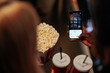 © bernardbodo - People booking movie theater seats with mobile app.