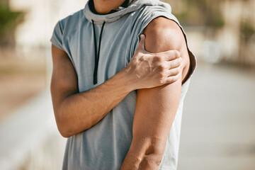 Poster - Arm, mockup and man in street with injury or ache in fitness, sports or cardio on blurred background. Shoulder pain, runner and hands of guy suffering heart attack sign, accident or risk in workout