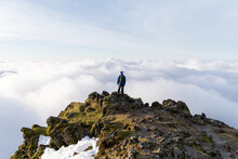 Person On Top Of A Mountain Above The Clouds. Snowdon, Wales, UK. Hiking And Tourism. 