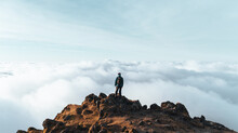 Person On Top Of A Mountain Above The Clouds. Snowdon, Wales, UK. Hiking And Tourism. 