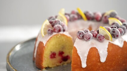 Poster - Step by step. Slicing lemon cranberry bundt cake decorated with sugar cranberries and lemon wedges.