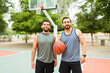 © AntonioDiaz - Smiling young men exercising playing basketball