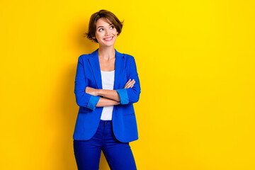 Wall Mural - Photo of confident beautiful pretty woman successful person folded hands look empty space presentation info isolated on yellow color background