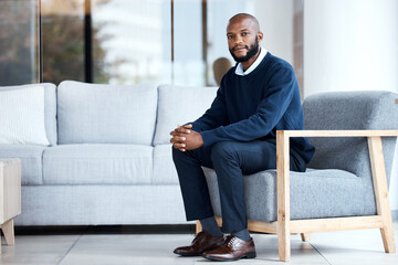 Psychologist, waiting and black man sitting on chair at work, job or modern workplace in modern office lounge. Portrait, employee and African American businessman or therapist with positive mindset