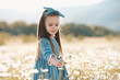 © morrowlight - Happy child girl 3-4 year old walk in chamomile meadow pick up flowers outdoor. Springtime. Childhood.