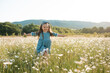 © morrowlight - Happy cheerful child girl 3-4 year old walk in chamomile meadow having fun pick up flowers outdoor. Springtime.