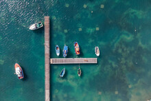 Aerial View Of Fishing Boat Docked At The Pier In Marzamemi Harbour, Pachino, Syracuse, Sicily, Italy.