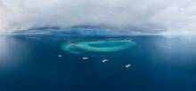 Panoramic Aerial View Of Luxury Yachts Docked Along The Atoll On Maldives Archipelagos.