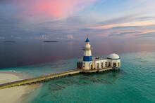 Aerial View Of A Lighthouse Of A Luxury Resort On A Small Island, Laccadive Sea, Indian Ocean, Maldives Archipelagos.