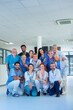 © Halfpoint - Portrait of happy doctors, nurses and other medical staff in hospital.