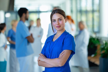 Portrait of young woman doctor at hospital corridor.