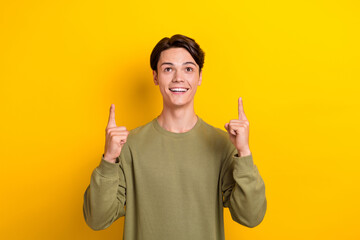 Canvas Print - Photo of nice positive person look direct fingers empty space isolated on yellow background